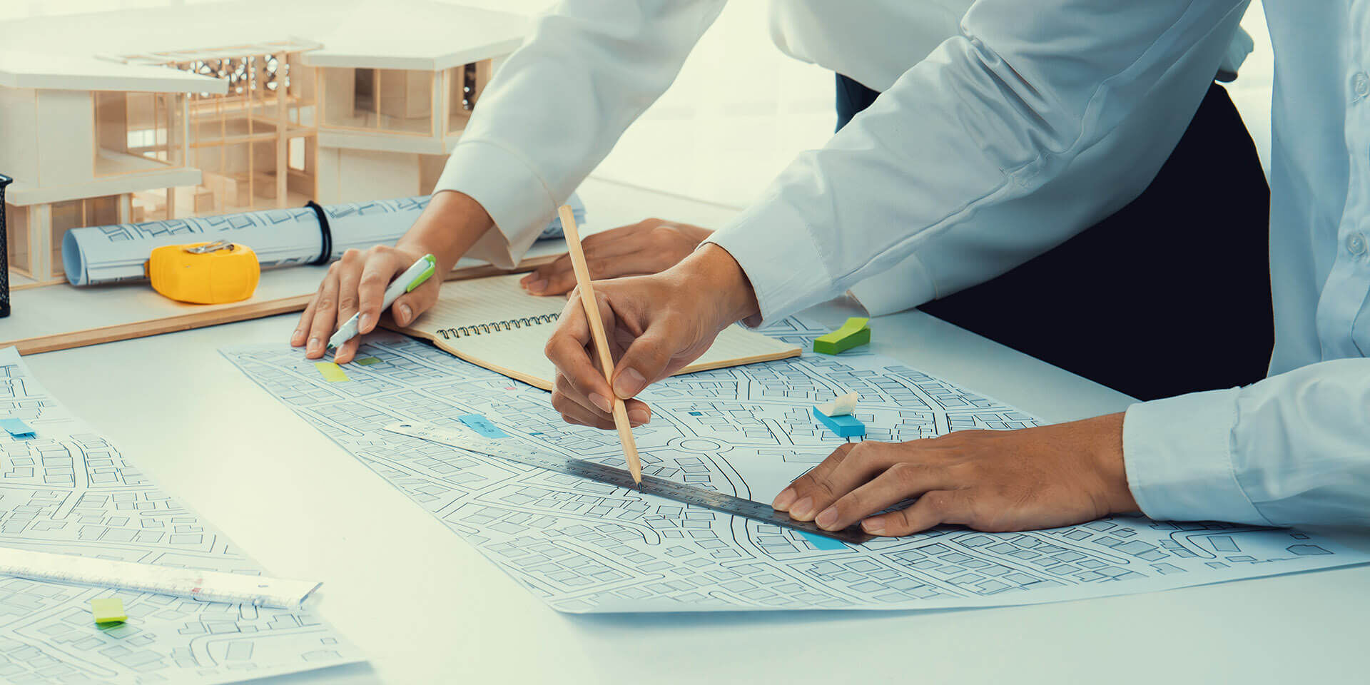 Worker, architect and engineer work on real estate construction project oratory